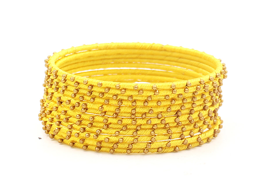 Thread Bangles Set of 12 with golden bearing by Leshya